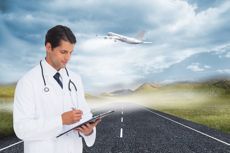 Composite image of smiling doctor holding pen and clipboard.jpeg