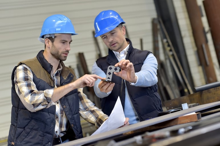 Engineer with mechanical worker checking on production.jpeg