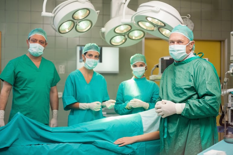 Medical team surrounding a patient in a surgical room.jpeg